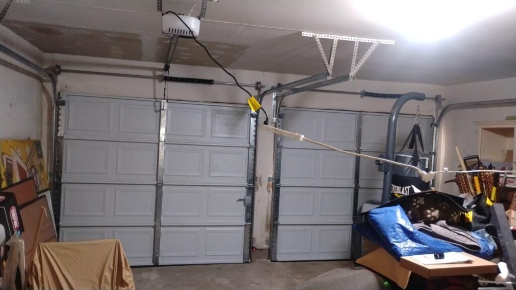 Broken garage door spring with temporary support before repair
